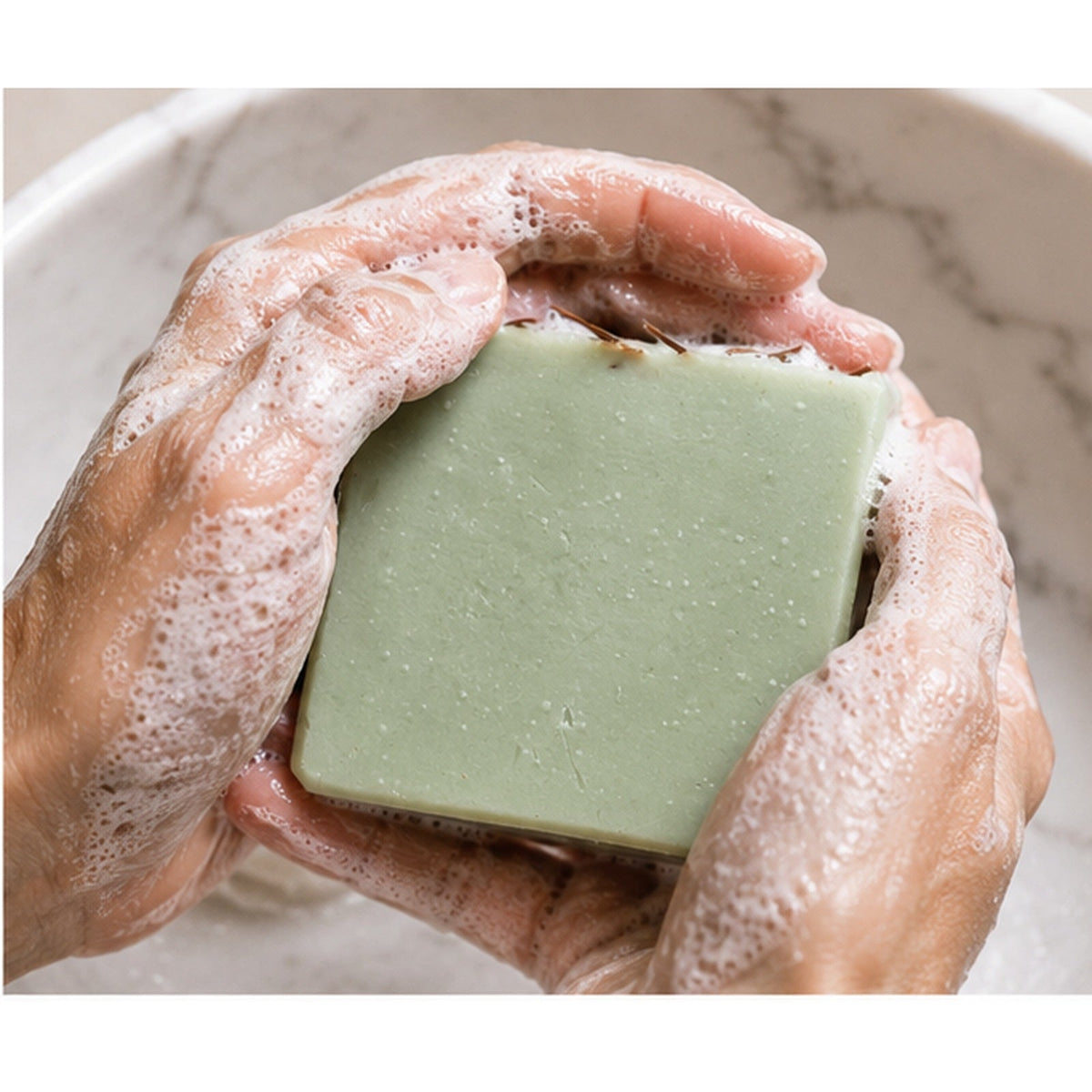 Grounded Alpine handmade soap lathered in hands