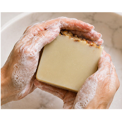 Grounded Citrus Sunrise handmade soap lathered in hands
