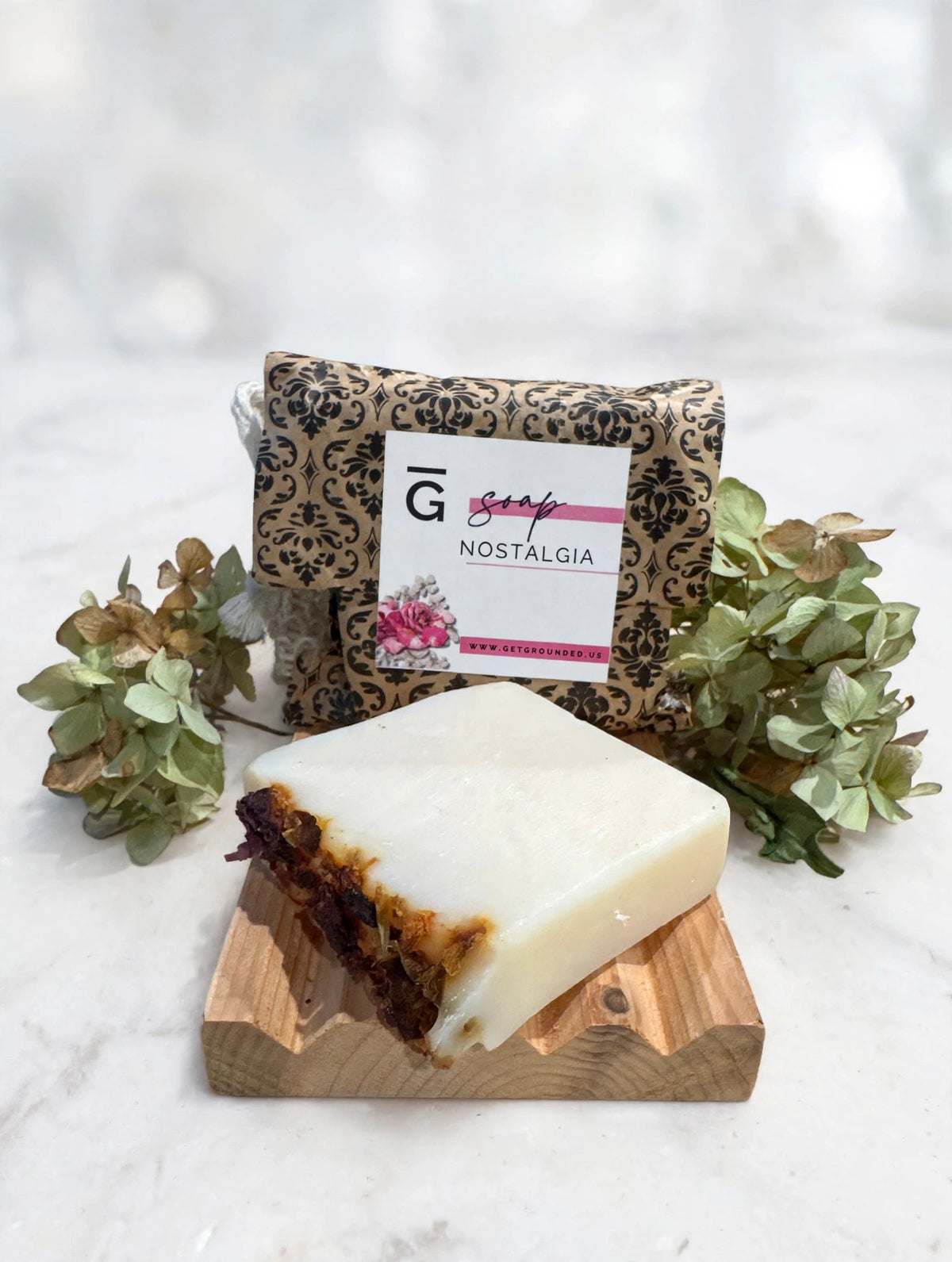 Nostalgia tallow soap bar with vanilla, rose and flower petals on marble